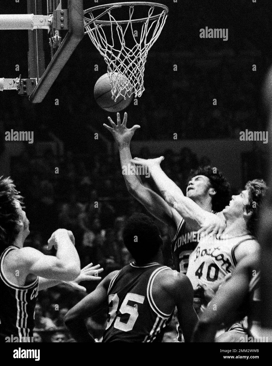 https://c8.alamy.com/comp/2MM2WWB/file-in-this-march-22-1974-file-photo-connecticuts-tony-hanson-top-right-and-boston-colleges-mark-raterink-40-contend-for-a-rebound-during-an-national-invitation-tournament-college-basketball-game-at-madison-square-garden-in-new-york-hanson-died-sunday-nov-25-2018-at-his-home-in-windham-conn-he-was-63-ap-photo-file-2MM2WWB.jpg