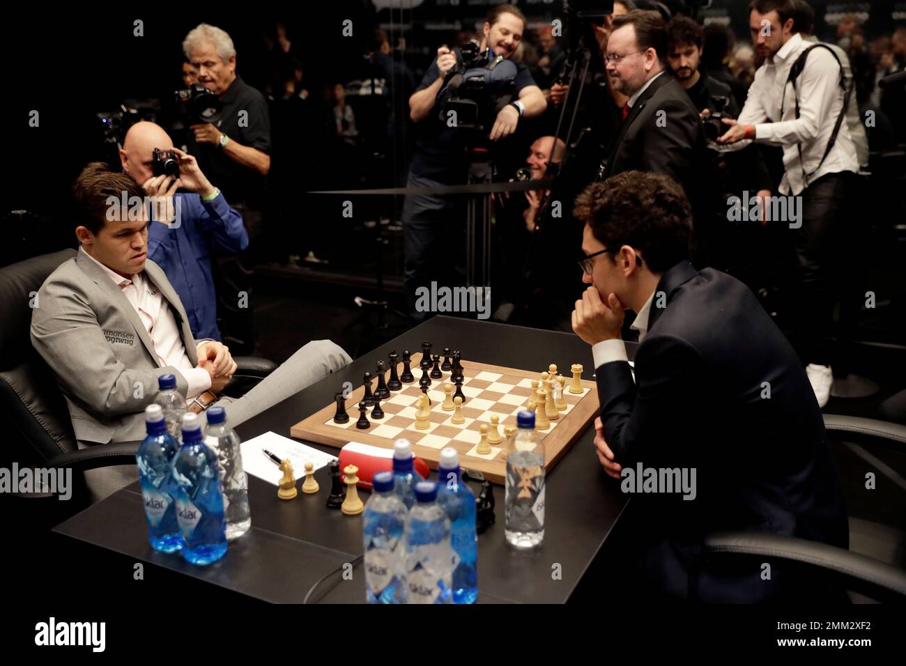 Reigning chess world champion Magnus Carlsen, right, from Norway, plays  Italian-American challenger Fabiano Caruana in the first five minutes of  round three of their World Chess Championship Match in London, Monday, Nov.