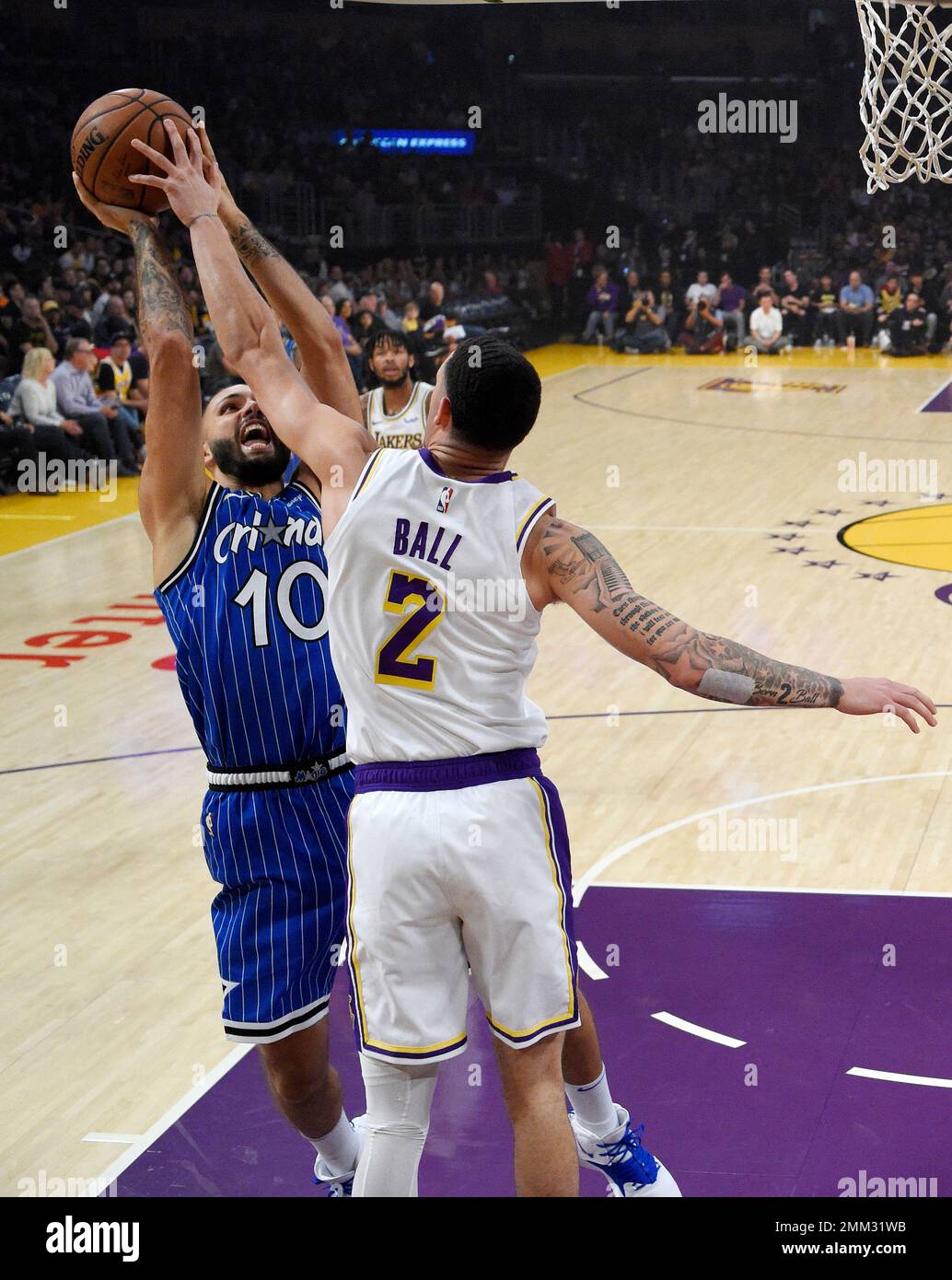 Los Angeles Lakers guard Lonzo Ball, right, blocks the shot of Orlando  Magic guard Evan Fournier, of France, during the first half of an NBA  basketball game Sunday, Nov. 25, 2018, in