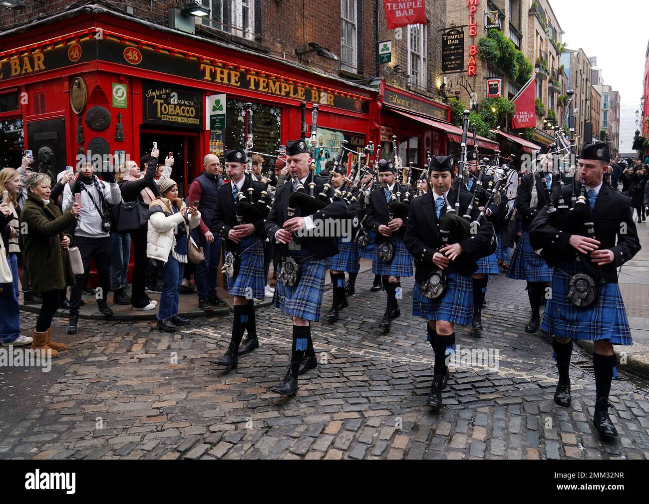 The Clew Bay Pipe Band as they march through the streets of Temple Bar, Dublin, as part of TradFest Temple Bar 2023. Ireland's largest trad and folk music festival TradFest ran from January 25th to 29th with over 85 concerts, 50 of which are free. Picture date: Sunday January 29, 2023. Stock Photo