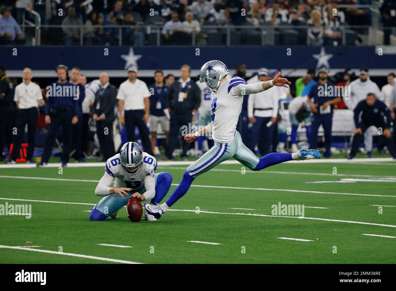 Dallas Cowboys kicker Brett Maher (right) kicks a field goal as