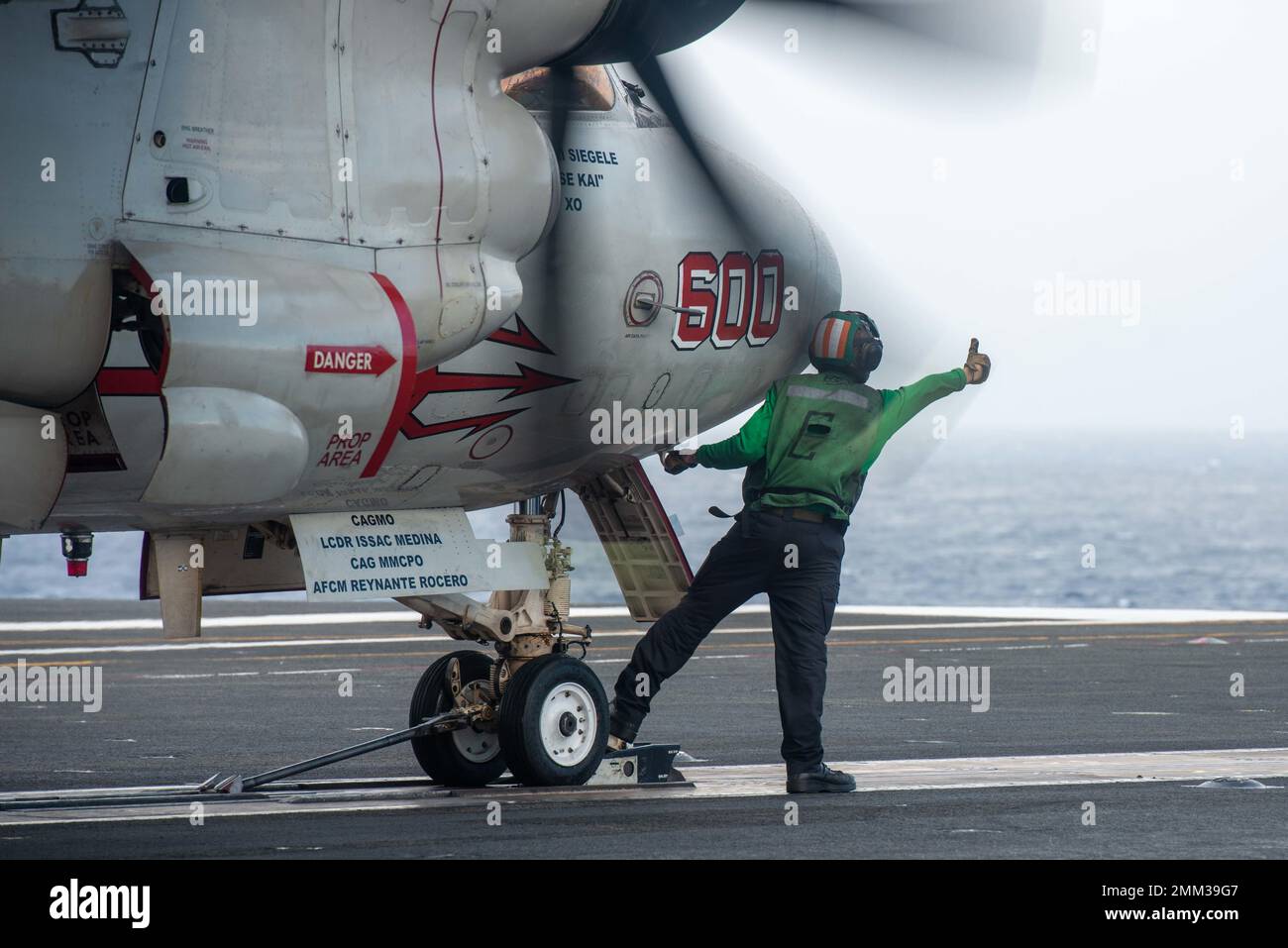 220914-N-LI114-1005 PACIFIC OCEAN (Sept. 14, 2022) Aviation Boatswain’s Mate (Equipment) Airman Noah Moon, from Toledo, Ohio, prepares an E-2D Hawkeye, attached to the Tiger Tails of Airborne Early Warning Squadron (VAW) 125, to launch from the flight deck of the U.S. Navy’s only forward-deployed aircraft carrier, USS Ronald Reagan (CVN 76), in the Pacific Ocean, Sept. 14. E-2D Hawkeyes perform tactical airborne, early warning missions to provide valuable information to Carrier Strike Group 5 as it plans and executes operations. Ronald Reagan, the flagship of Carrier Strike Group 5, provides a Stock Photo