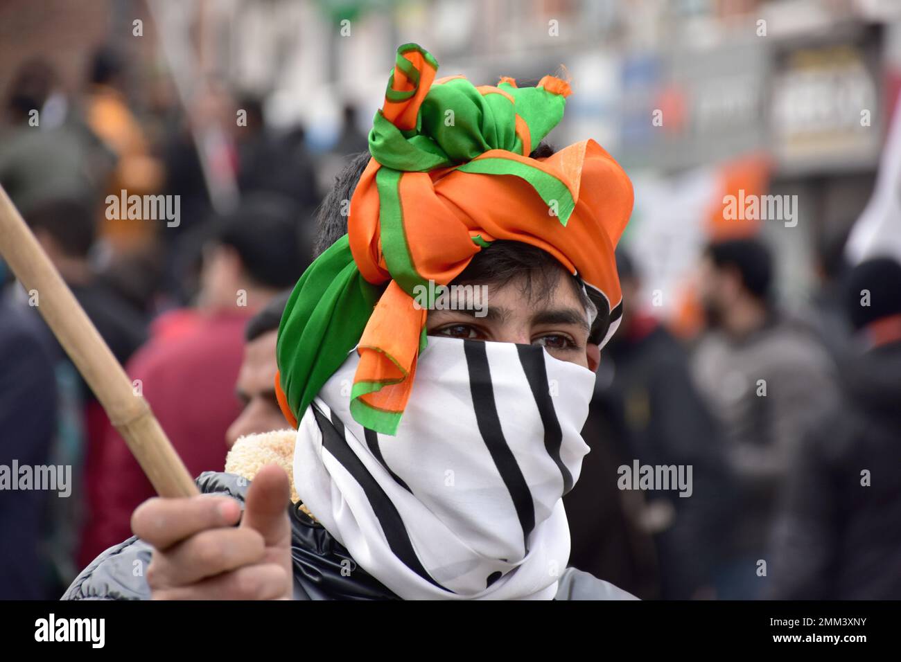 Srinagar, India. 29th Jan, 2023. A supporter of Indian National Congress covers his face with a party flag during a 'Bharat Jodo Yatra' march in Srinagar. Congress leader Rahul Gandhi resumed his 'Bharat Jodo Yatra' in Srinagar on Sunday, as the foot march entered its last day. Gandhi, along with his sister were joined by hundreds of Congress supporters, including women, who were seen carrying the tricolour and party flags. (Photo by Saqib Majeed/SOPA Images/Sipa USA) Credit: Sipa USA/Alamy Live News Stock Photo