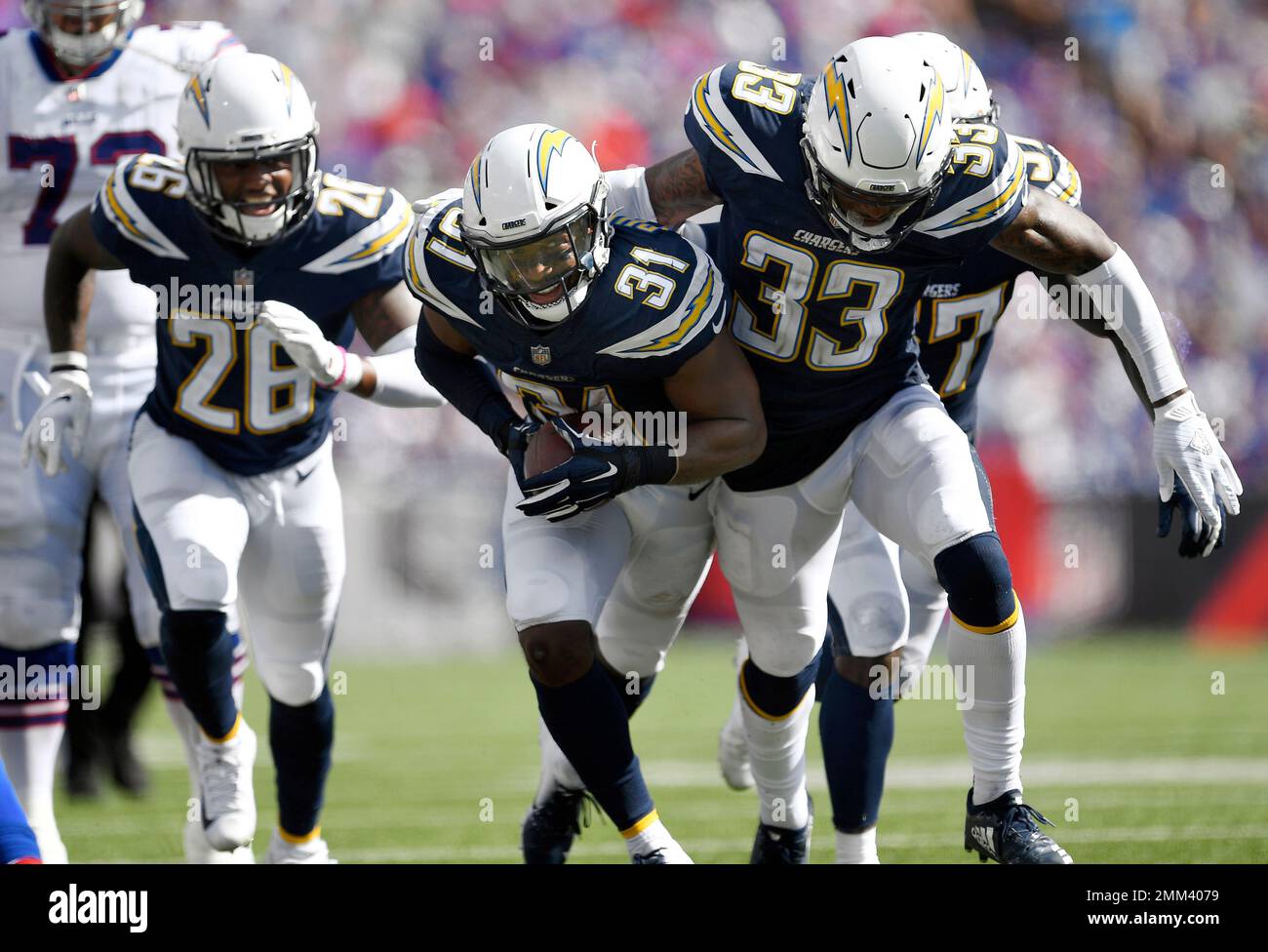 Los Angeles Chargers players celebrate an interception by safety Adrian ...