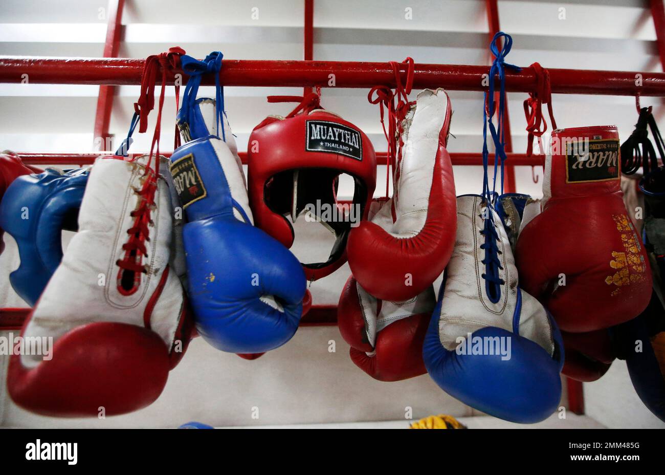 In this Wednesday, Nov. 14, 2018, photo, Thai kickboxing gloves and headgear hang at a training