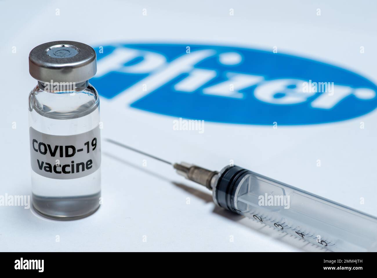 Qingdao,ShandongChina-Jan 29 2023:Covid-19 vaccine pfizer bottles on abstract background Stock Photo