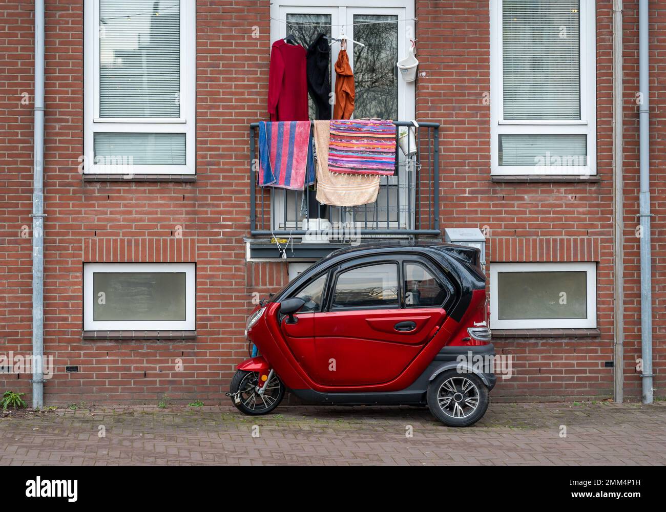 Amsterdam, The Netherlands, 28.01.2023, Small electric tricycle parked in the street Stock Photo