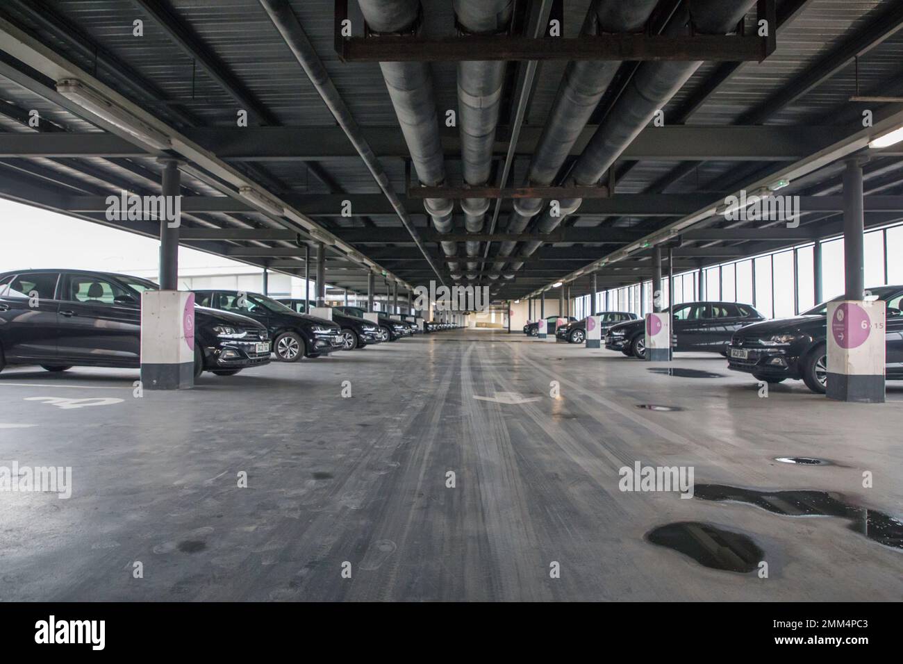 Multi Story Car Park with lines of all the same cars Stock Photo
