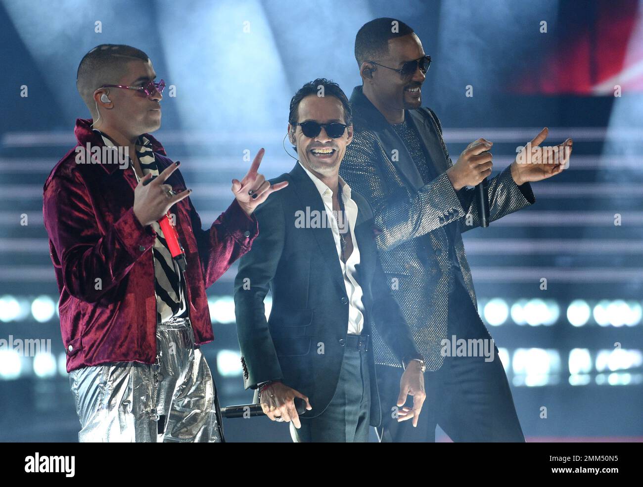 Bad Bunny, from left, Marc Anthony and Will Smith perform "Esta Rico