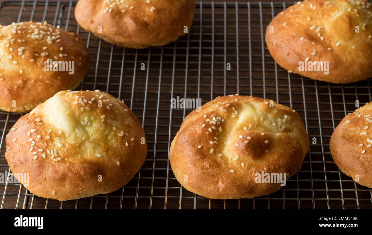 Homemade low carb ketogenic buns on a cooling rack, fresh out of the oven. Stock Photo