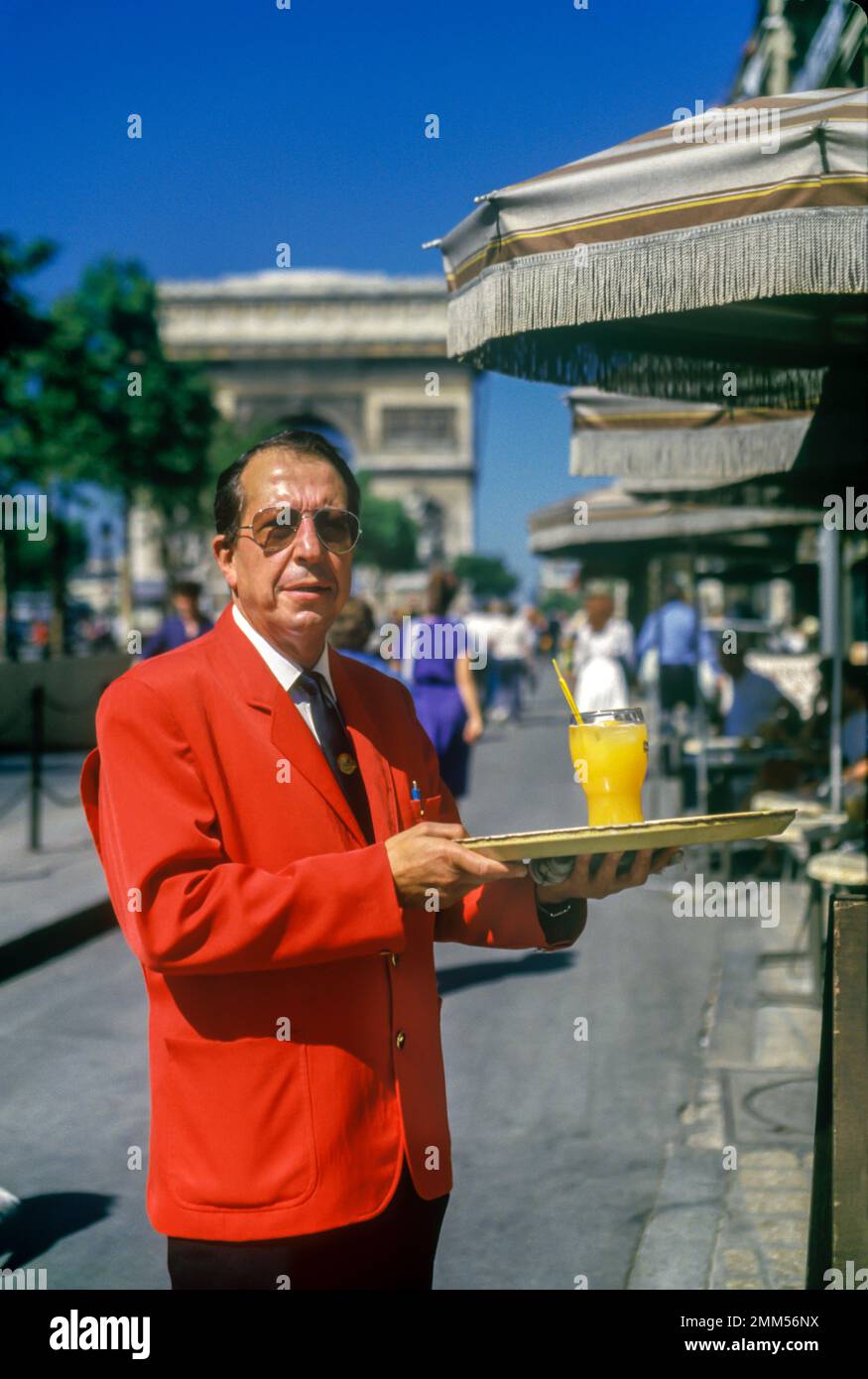 1987 HISTORICAL WAITER CAFE CHAMPS ELYSEES PARIS FRANCE Stock Photo
