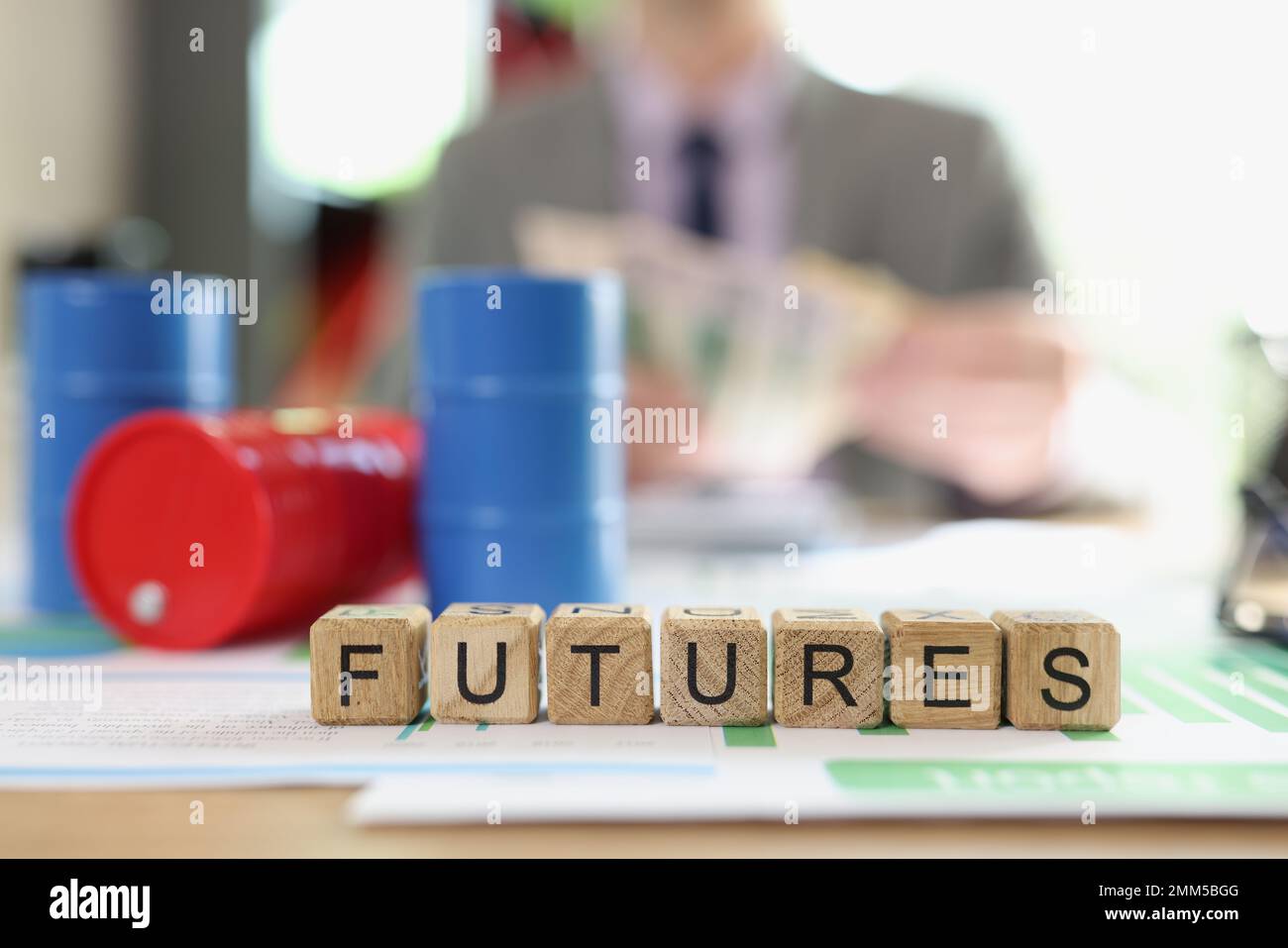 Word futures collected from wooden cubes and oil barrels on financial statements. Stock Photo