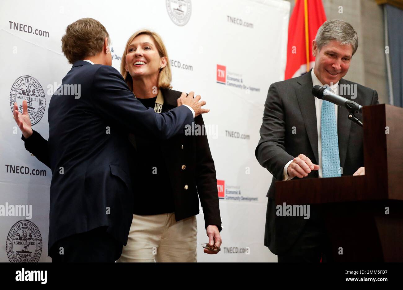 Holly Sullivan, center, of Amazon Public Policy, hugs Tennessee Gov