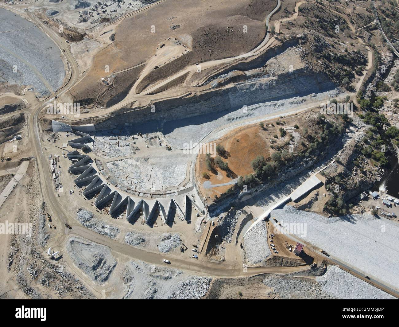 An aerial view of the labyrinth weir, emergency spillway, and service