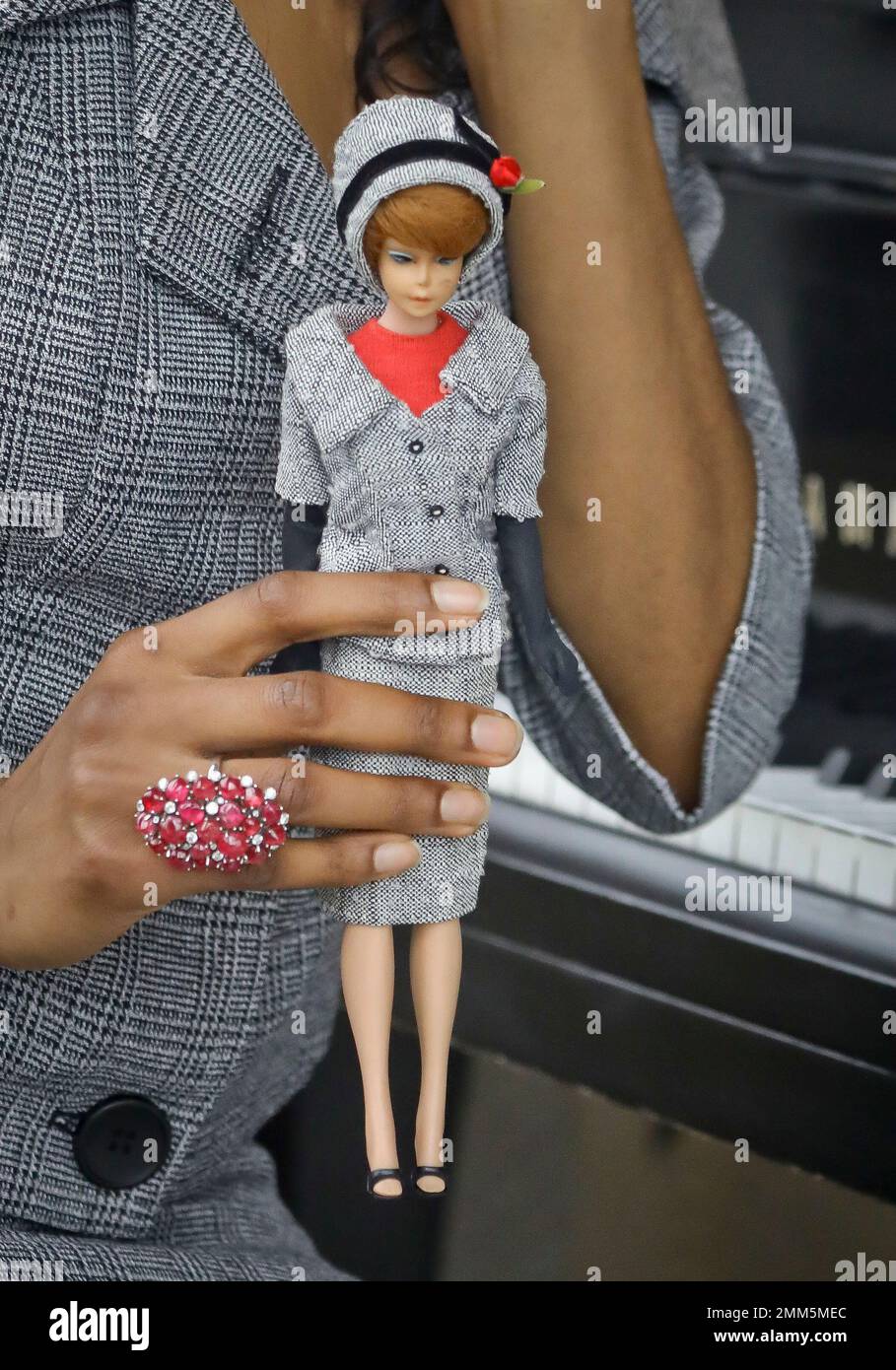 In this Nov. 5, 2018 photo, model Tiffany Hendrix holds a Barbie doll while  wearing a matching outfit by designer Katie Echeverry in New York.  Echeverry's company, Unique Vintage, based in Burbank,