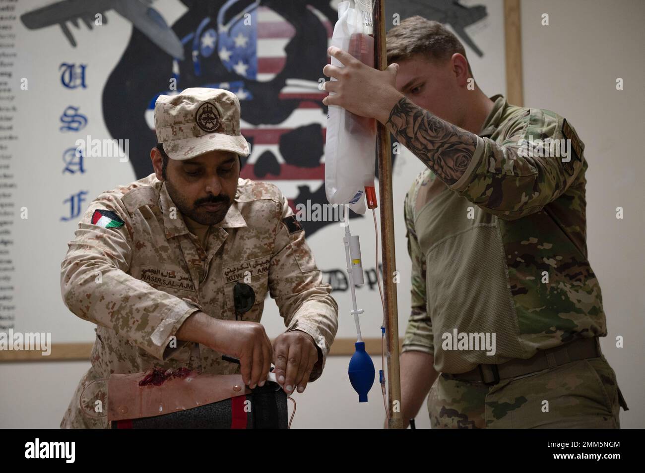 A Kuwait Army firefighter demonstrates how to properly apply a