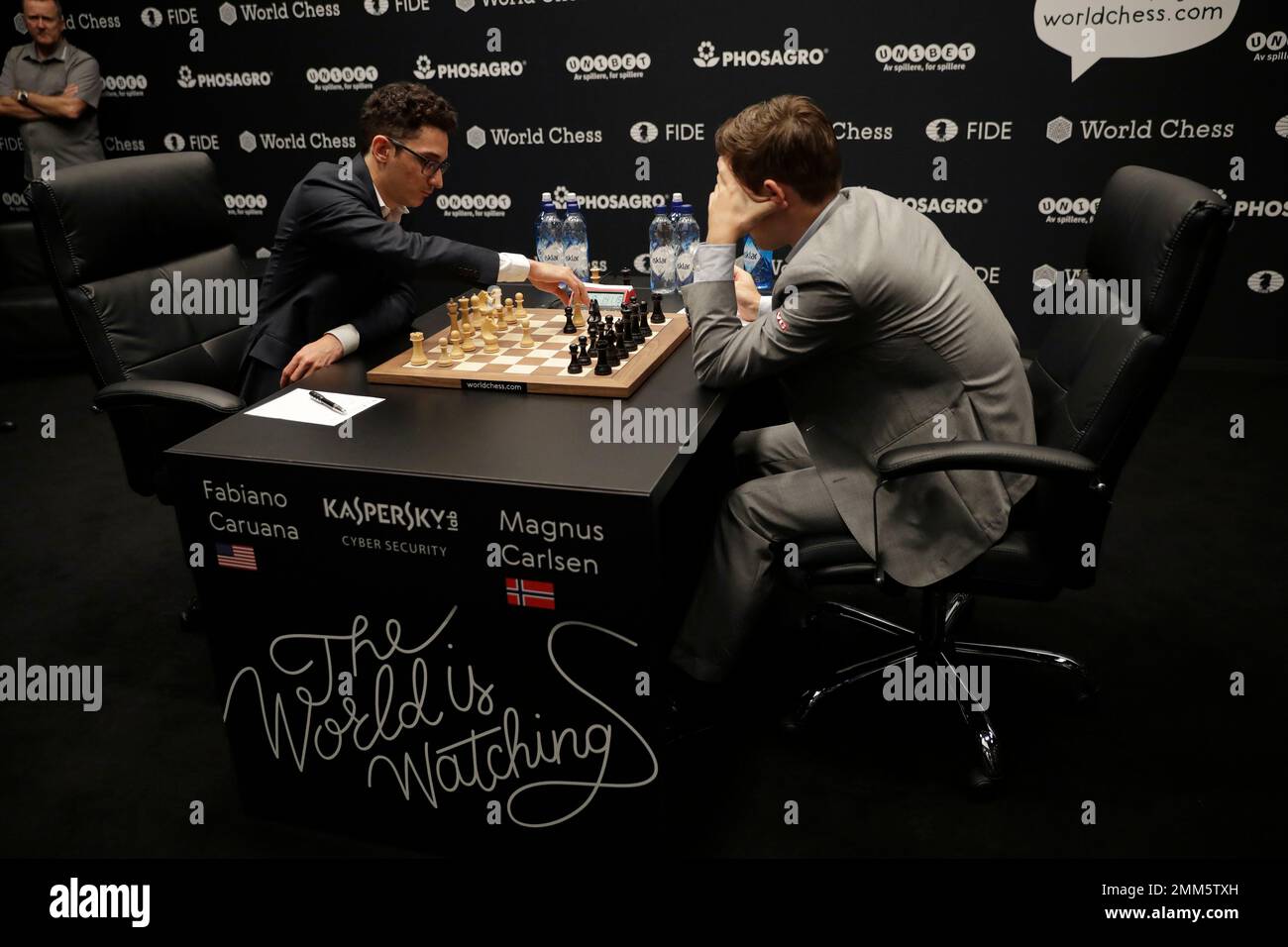 Reigning chess world champion Magnus Carlsen, right, from Norway, plays  Italian-American challenger Fabiano Caruana in the first five minutes of  round three of their World Chess Championship Match in London, Monday, Nov.