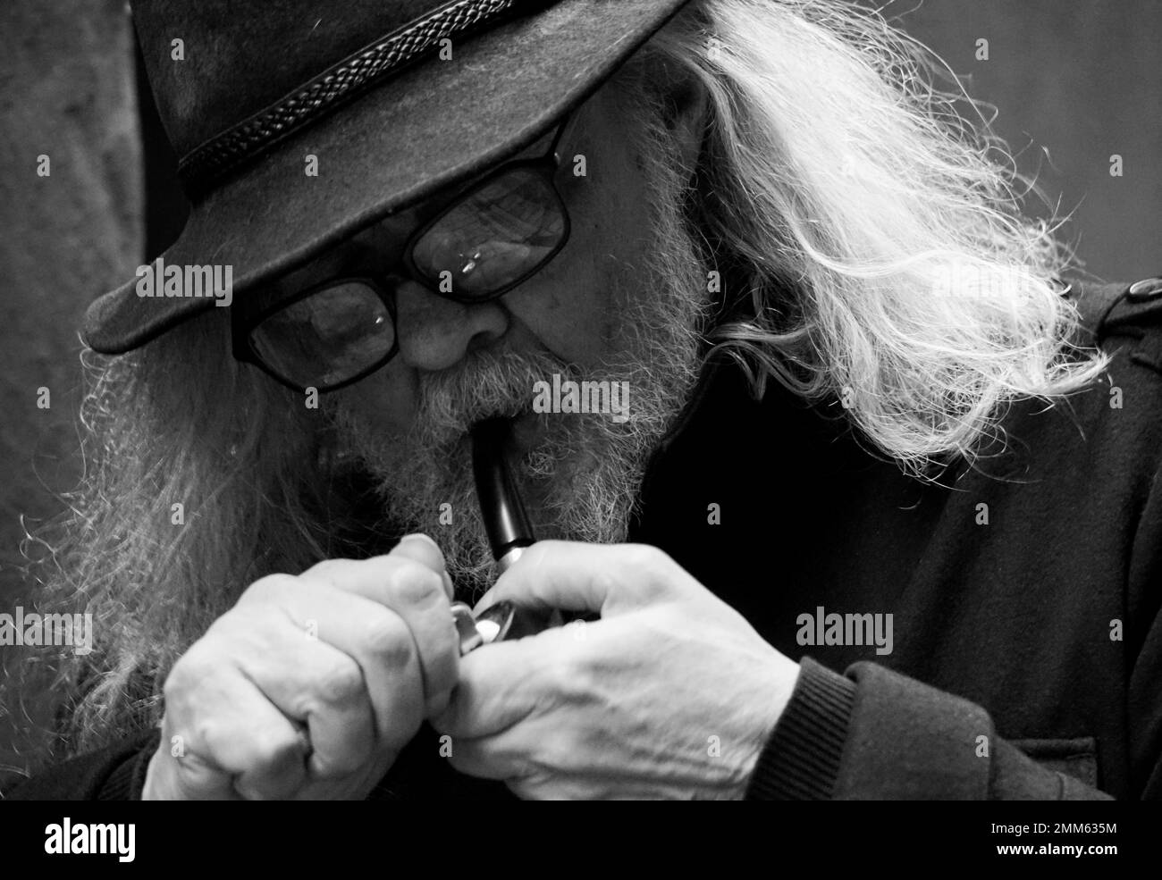 Close up of a old man smoking pipe Stock Photo