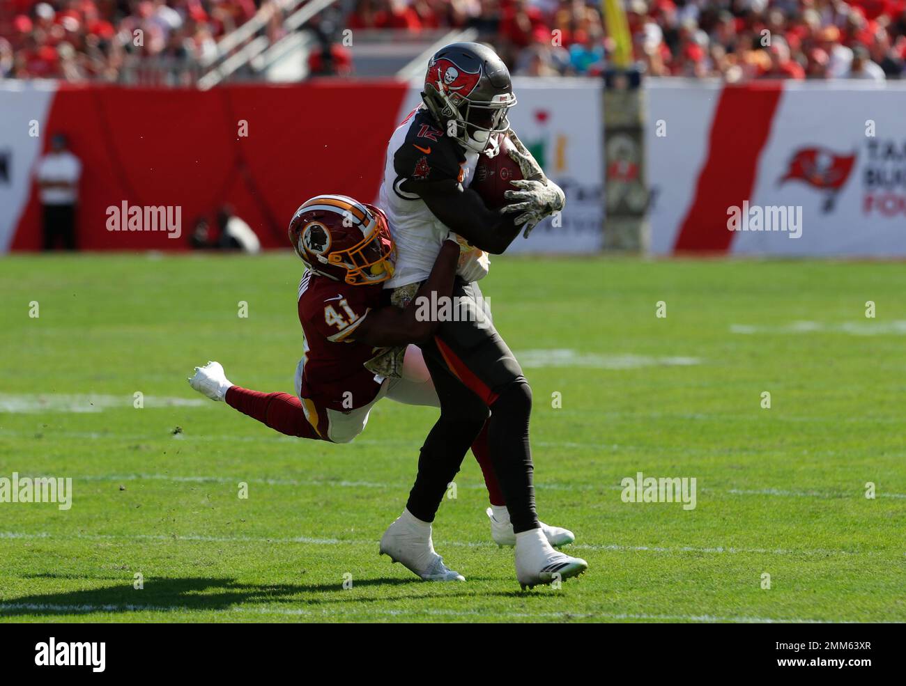 Tampa Bay Buccaneers wide receiver Chris Godwin (12) is stopped by Washington  Redskins defensive back Danny Johnson (41) during the first half of an NFL  football game Sunday, Nov. 11, 2018, in