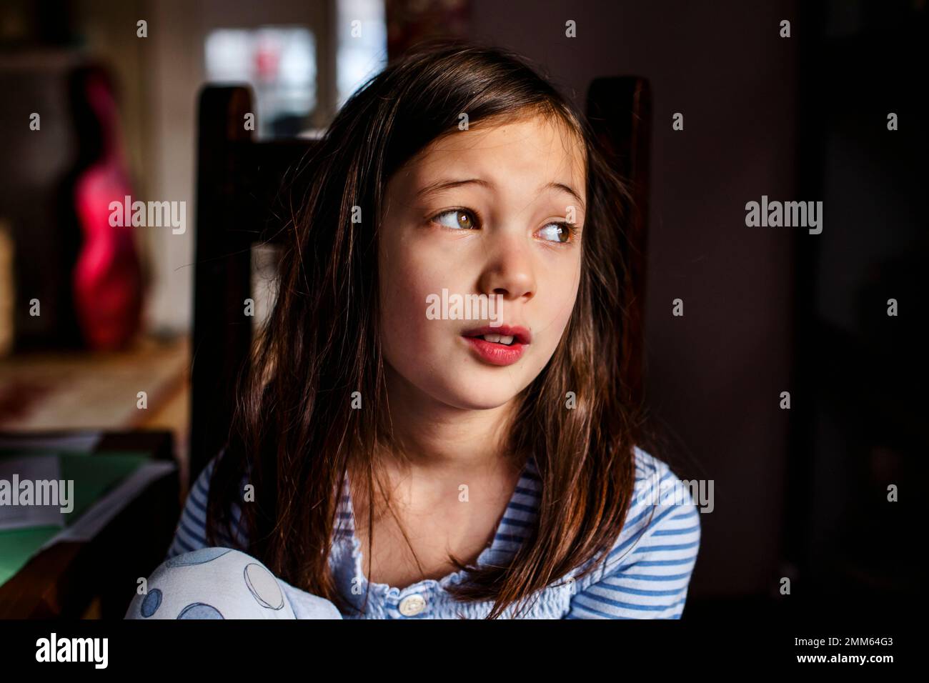 Portrait of young girl sitting in chair by window Stock Photo - Alamy