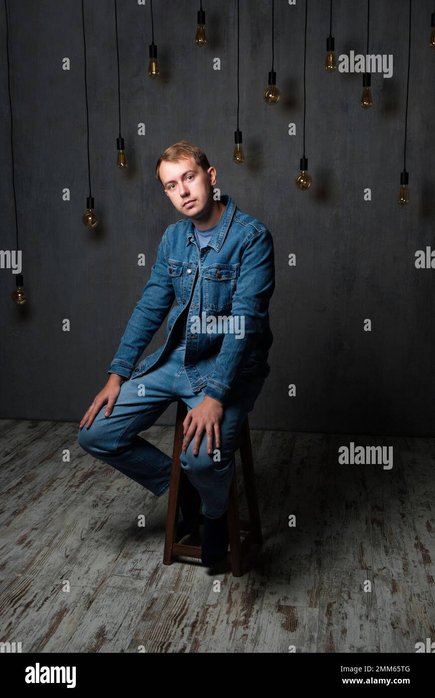 Portrait of young confident blond man in studio Stock Photo