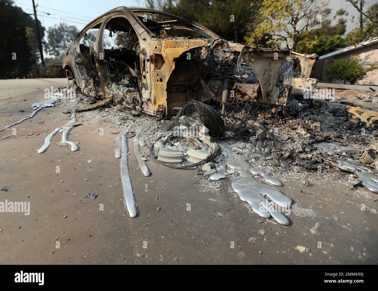 Molten aluminum has flowed from a car that burned in front of one of at least 20 homes destroyed just on Windermere Drive in the Point Dume area of Malibu, Calif., Saturday, Nov. 10, 2018. Known as the Woolsey Fire, it has consumed thousands of acres and destroyed dozens of homes. (AP Photo/Reed Saxon) Stock Photo