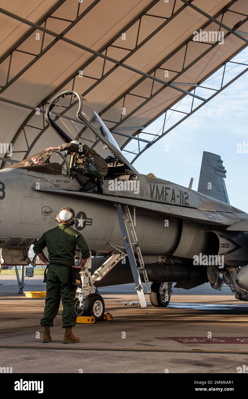 Marines attached to Marine Fighter Attack Squadron (VMFA) 112, Marine Aircraft Group 41, 4th Marine Aircraft Wing, conduct pre-flight checks on an F/A-18C Hornet at Naval Air Station Joint Reserve Base Fort Worth, Texas, Sept. 15, 2022. VMFA-112 is participating in a joint long-range strike exercise with Marine Aerial Refueler Transport Squadron (VMGR) 234, VMFA-225, Marine Fighter Training Squadron (VMFT) 401 and U.S. Air Force 513th Operations Support Squadron. This large force exercise demonstrates MAG-41's ability to project long-range strike capability and integrate with the Marine Corps' Stock Photo