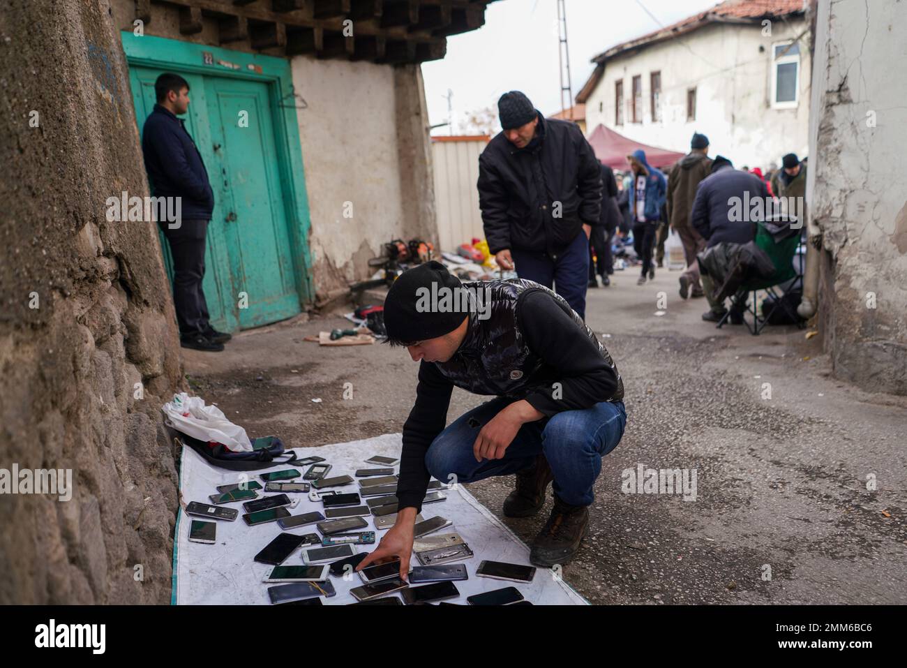 Ankara, Turkey. 29th Jan, 2023. A man examines used phones at a flea market. The flea market, which is set up during the weekends in Ankara Ulus Square, has been visited by more people in recent months due to the high inflation experienced in Turkey. The 64% inflation rate announced by the Turkish Statistical Institute (TUIK) is thought to be higher by many independent economical associations. (Credit Image: © Tunahan Turhan/SOPA Images via ZUMA Press Wire) EDITORIAL USAGE ONLY! Not for Commercial USAGE! Stock Photo