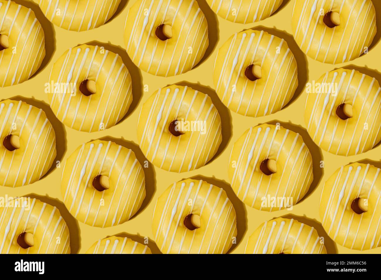 lemon doughnut in yellow glaze on a yellow background. pattern. Stock Photo