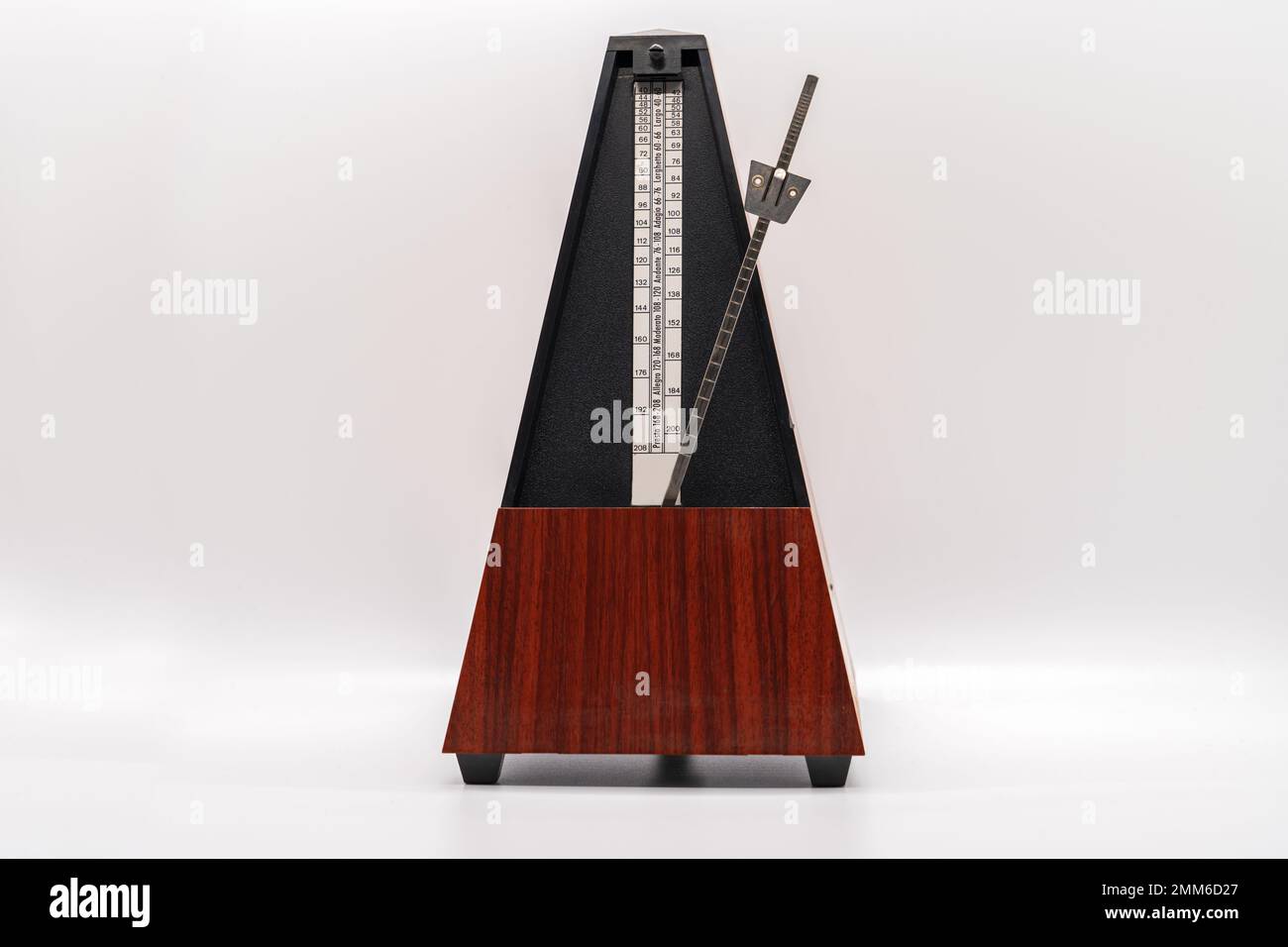 Old fashioned musical metronome isolated on a white background Stock