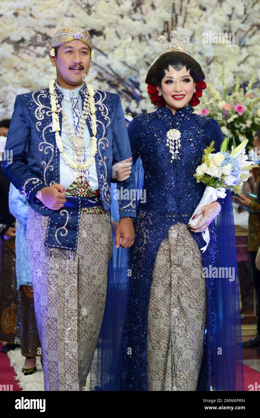 a wedding procession with Javanese tradition. The bride wears traditional Javanese dress.. Stock Photo