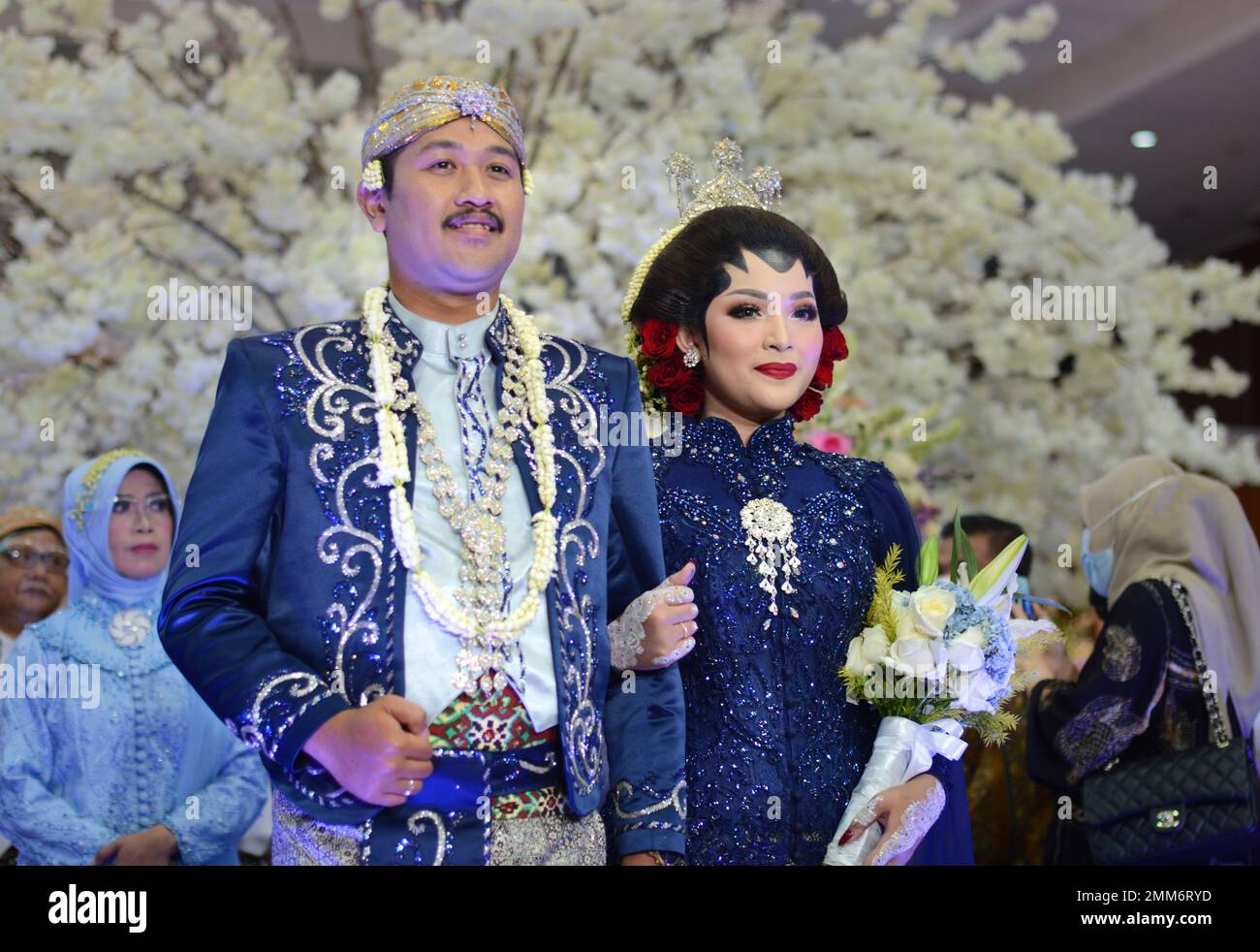 a wedding procession with Javanese tradition. The bride wears traditional Javanese dress.. Stock Photo