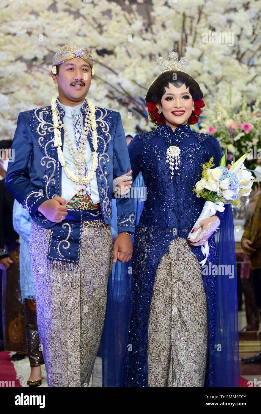 a wedding procession with Javanese tradition. The bride wears traditional Javanese dress.. Stock Photo