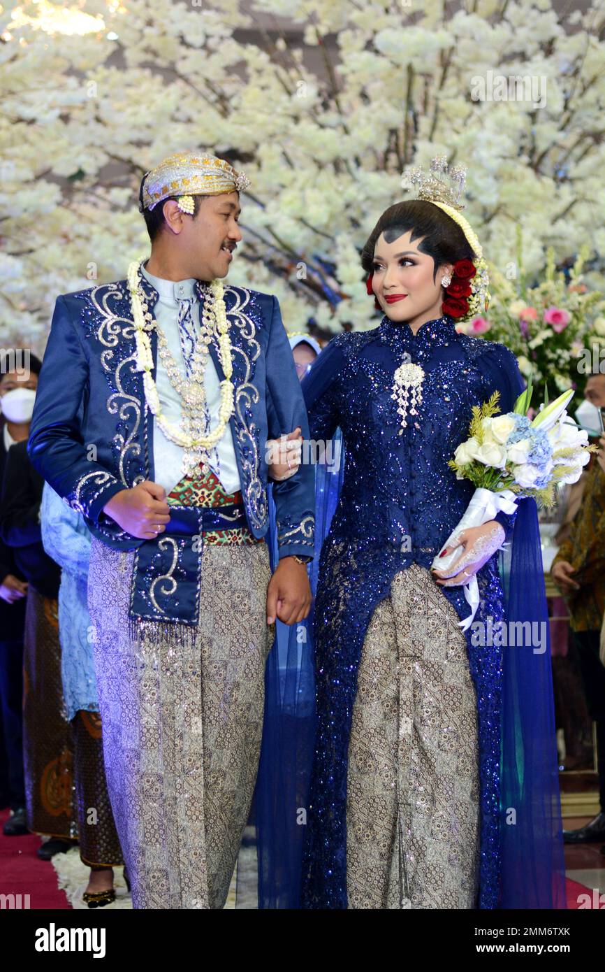 a wedding procession with Javanese tradition. The bride wears traditional Javanese dress.. Stock Photo