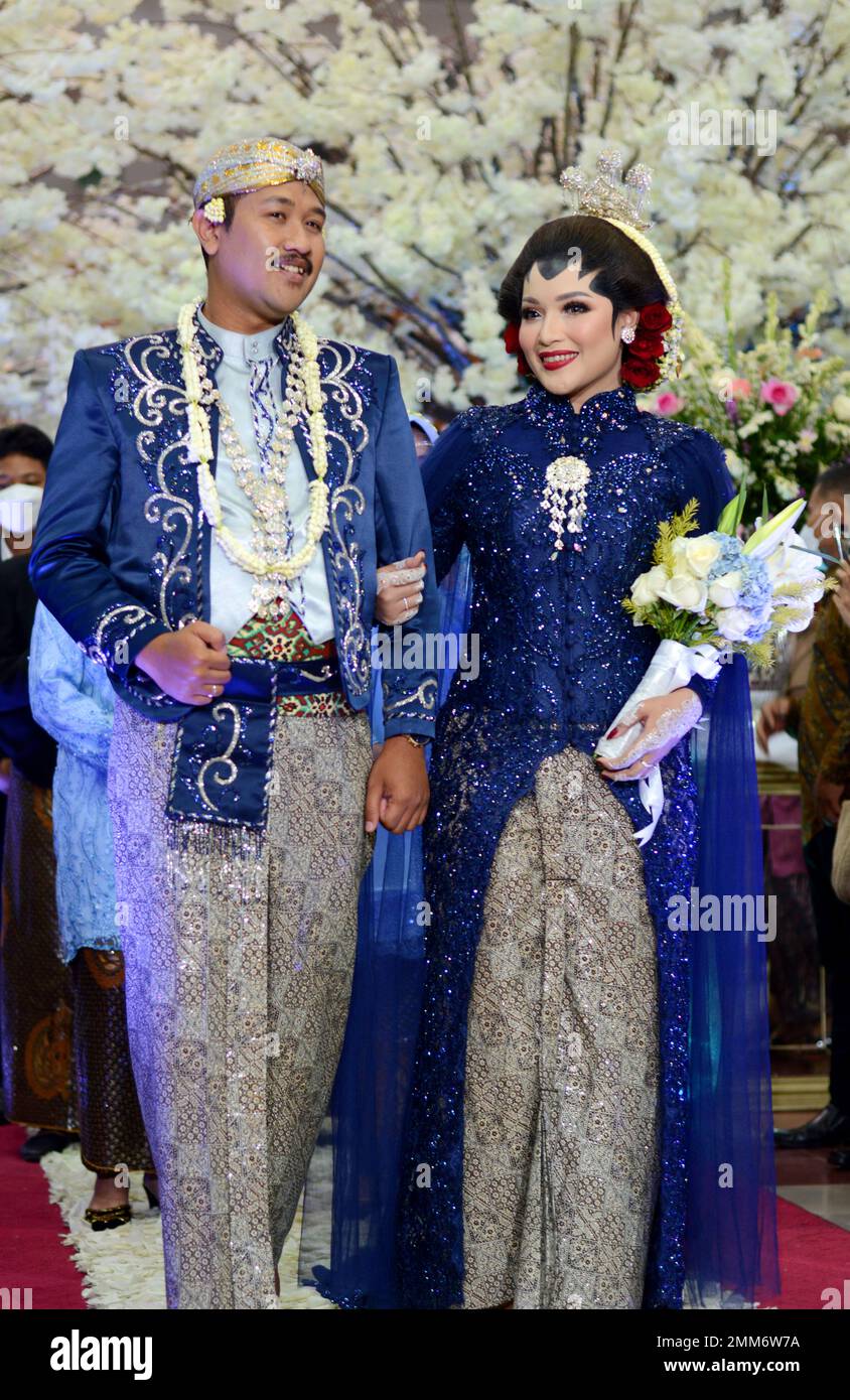 a wedding procession with Javanese tradition. The bride wears traditional Javanese dress.. Stock Photo