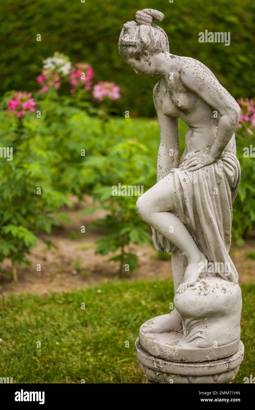 A statue in the classical style appears to step into the garden at the Briars Resort and Spa at Jackson Point, Lake Simcoe, Southern Ontario. Stock Photo