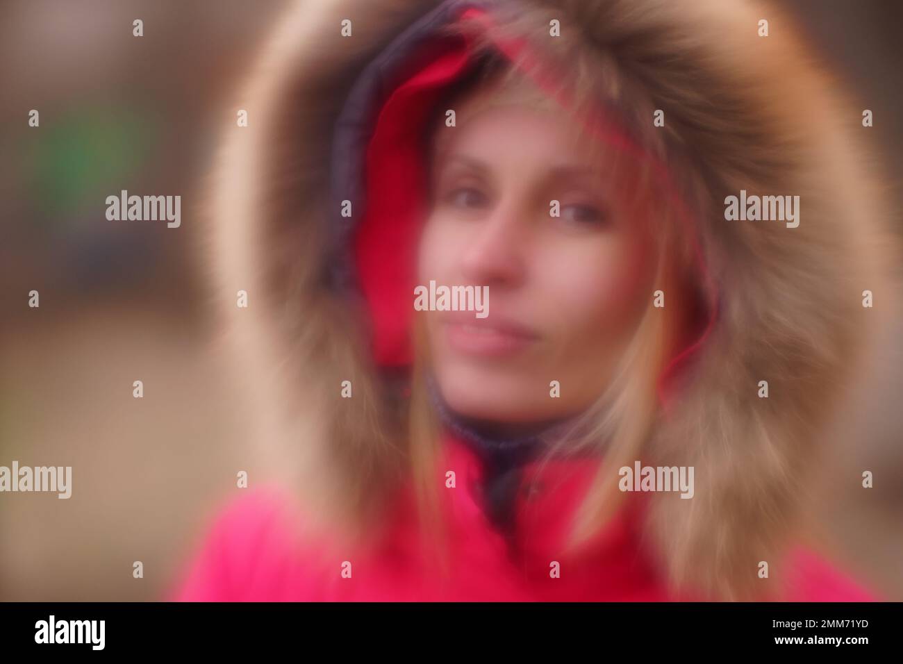 Young girl in a down jacket with fur hood, soft  blurred portrait Stock Photo