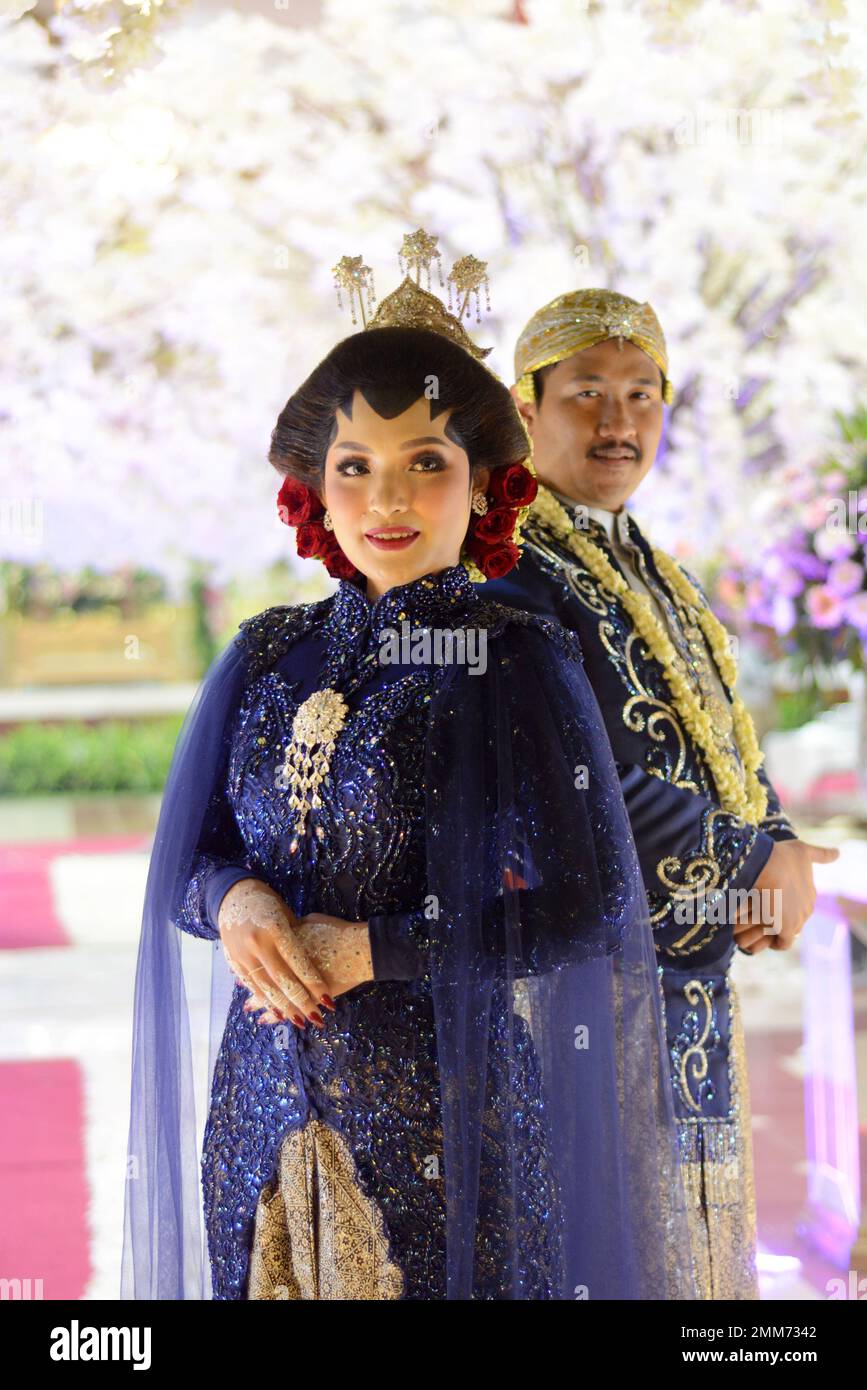 a wedding procession with Javanese tradition. The bride wears traditional Javanese dress.. Stock Photo