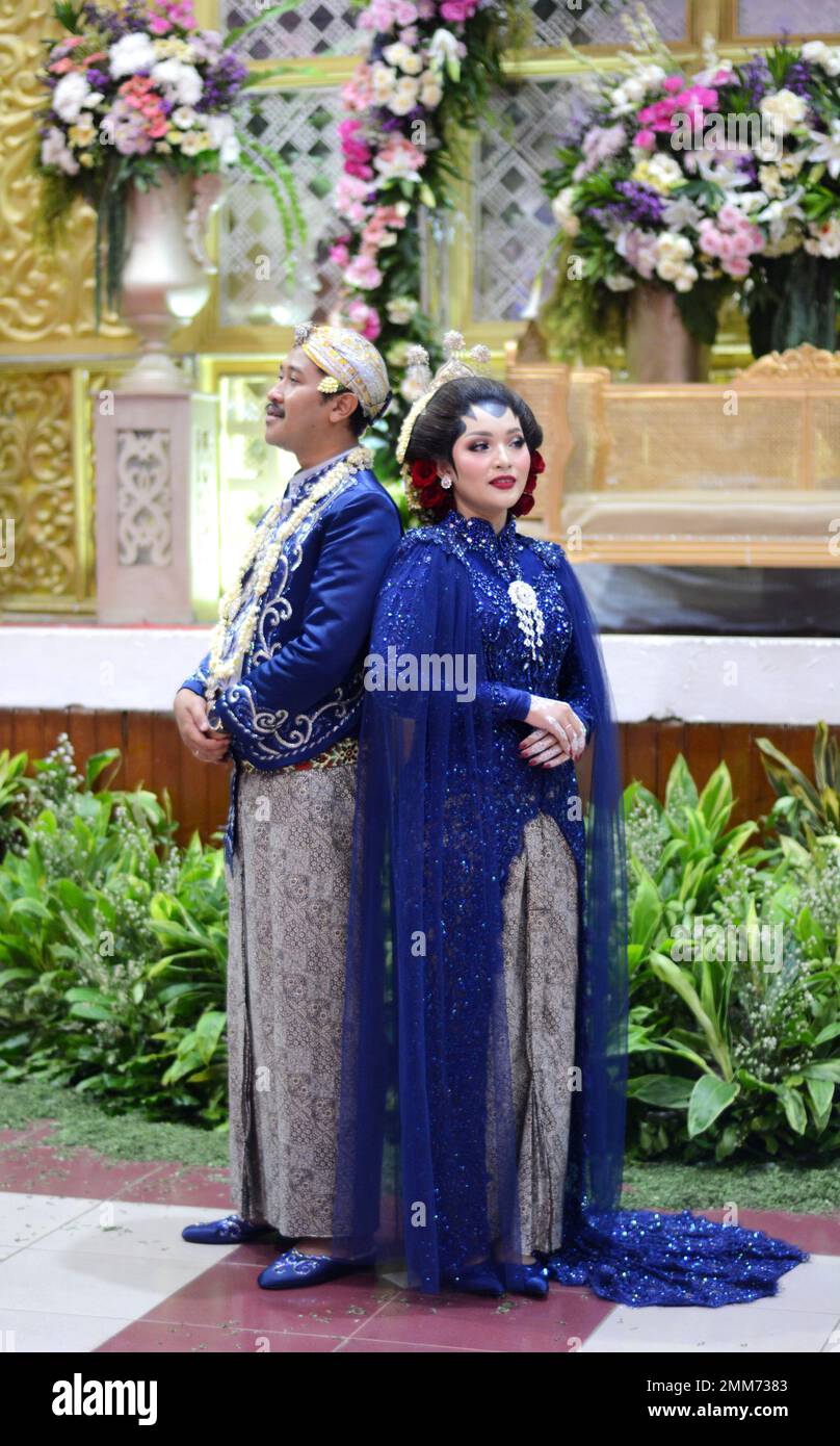 a wedding procession with Javanese tradition. The bride wears traditional Javanese dress.. Stock Photo