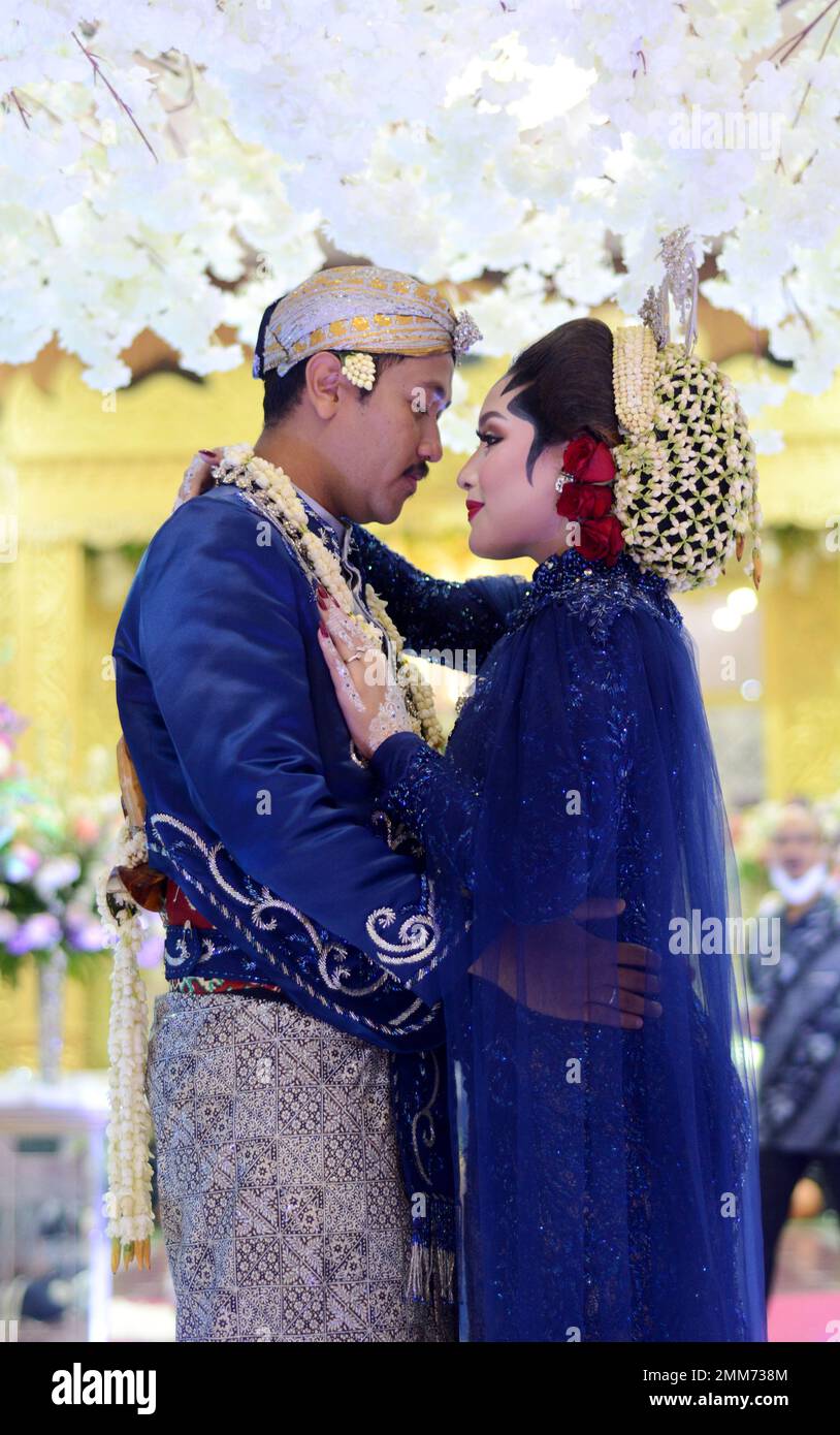 a wedding procession with Javanese tradition. The bride wears traditional Javanese dress.. Stock Photo