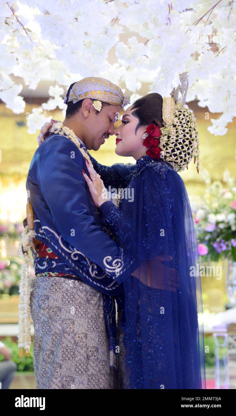 a wedding procession with Javanese tradition. The bride wears traditional Javanese dress.. Stock Photo