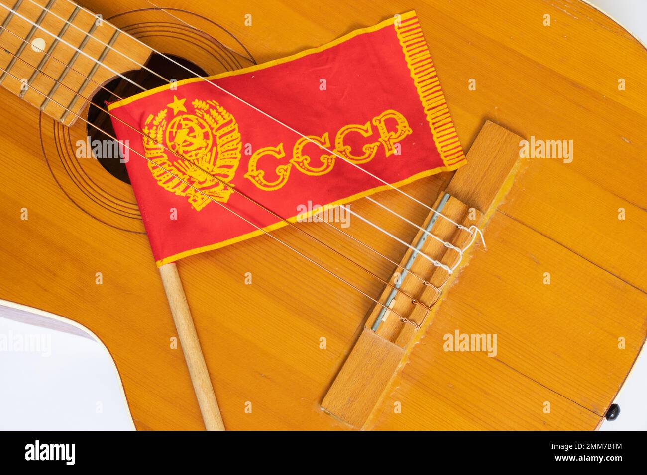 Red USSR flag on a stick and an guitar on a white background from Soviet times Stock Photo