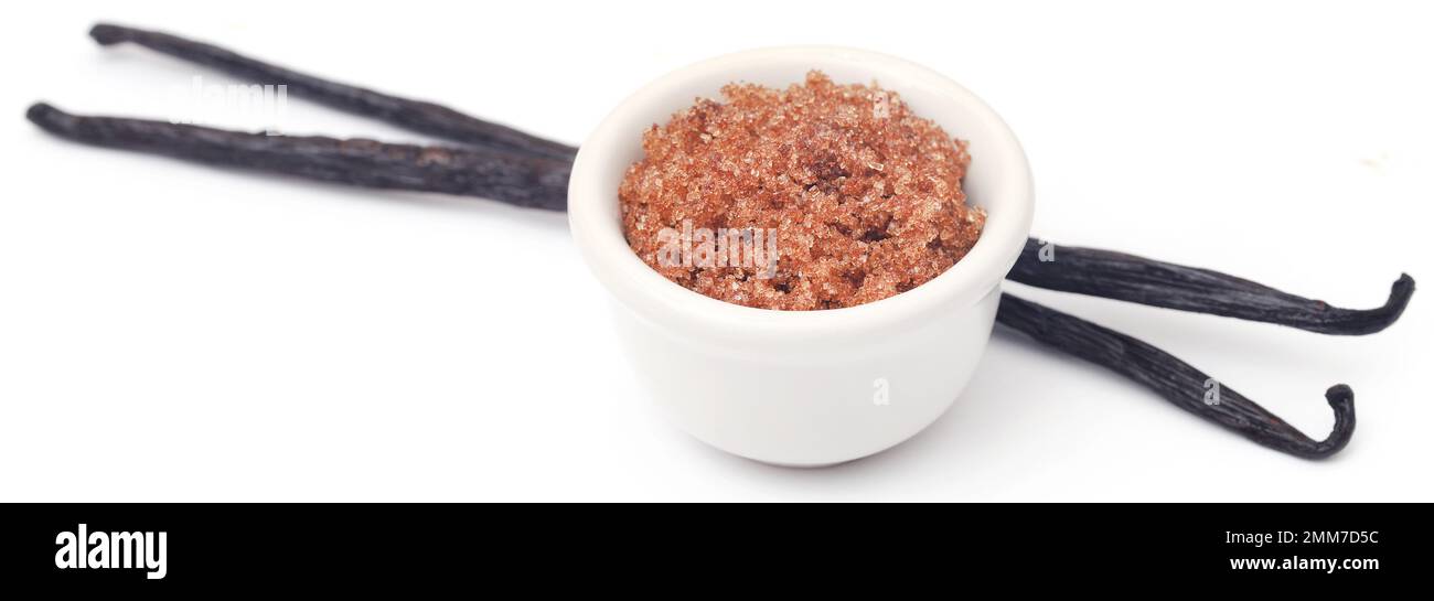 Vanilla pods with brown sugar isolated over white background Stock Photo