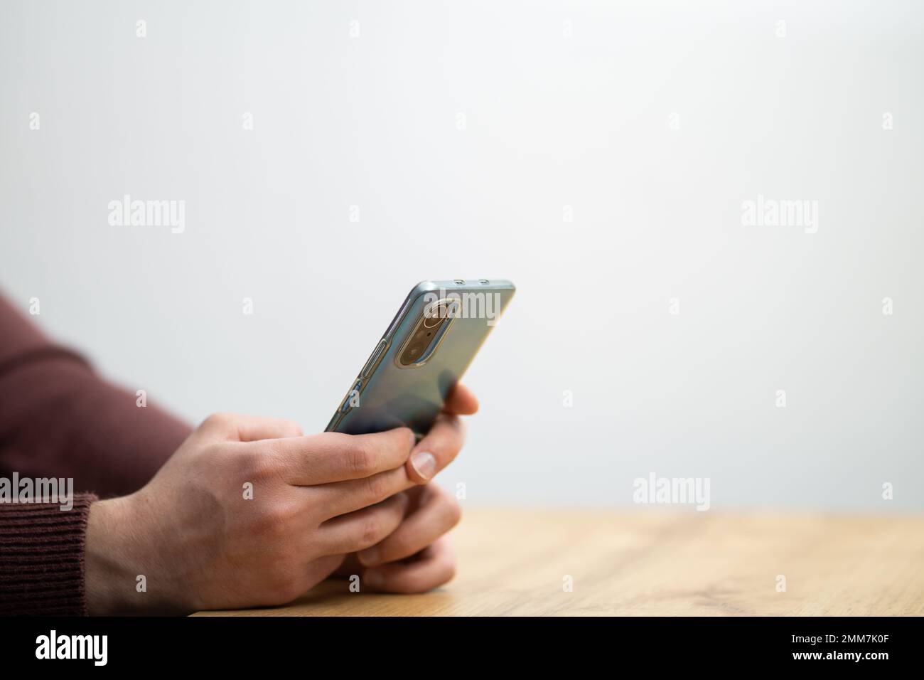 Man hands holding smartphone. Man using smartphone and pointing on the screen with one finger Stock Photo