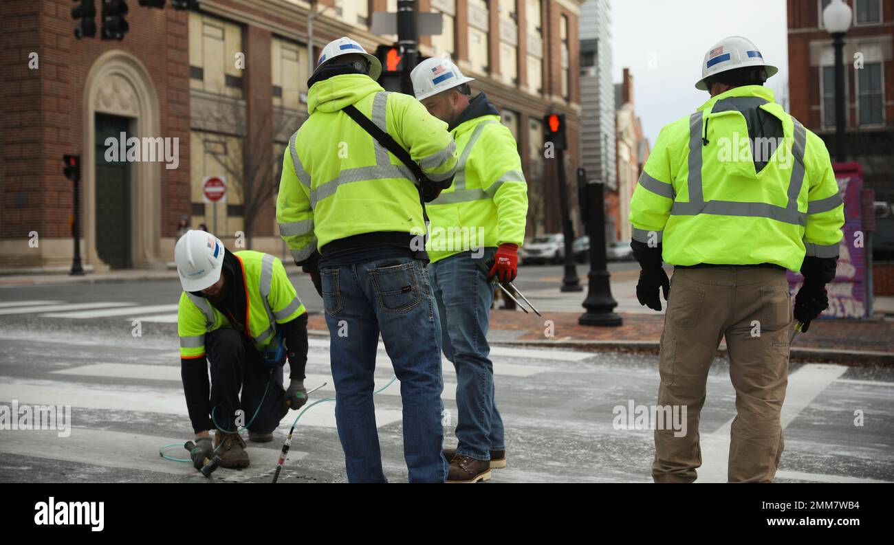 Construction Workers working at construction site yellow jacket helmet