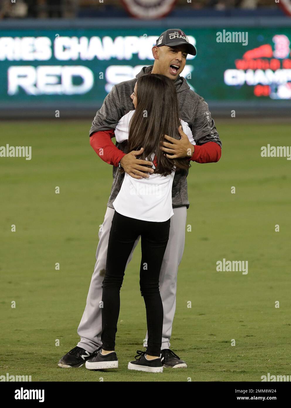 Boston Red Sox manager Alex Cora hugs his daughter Camilla after