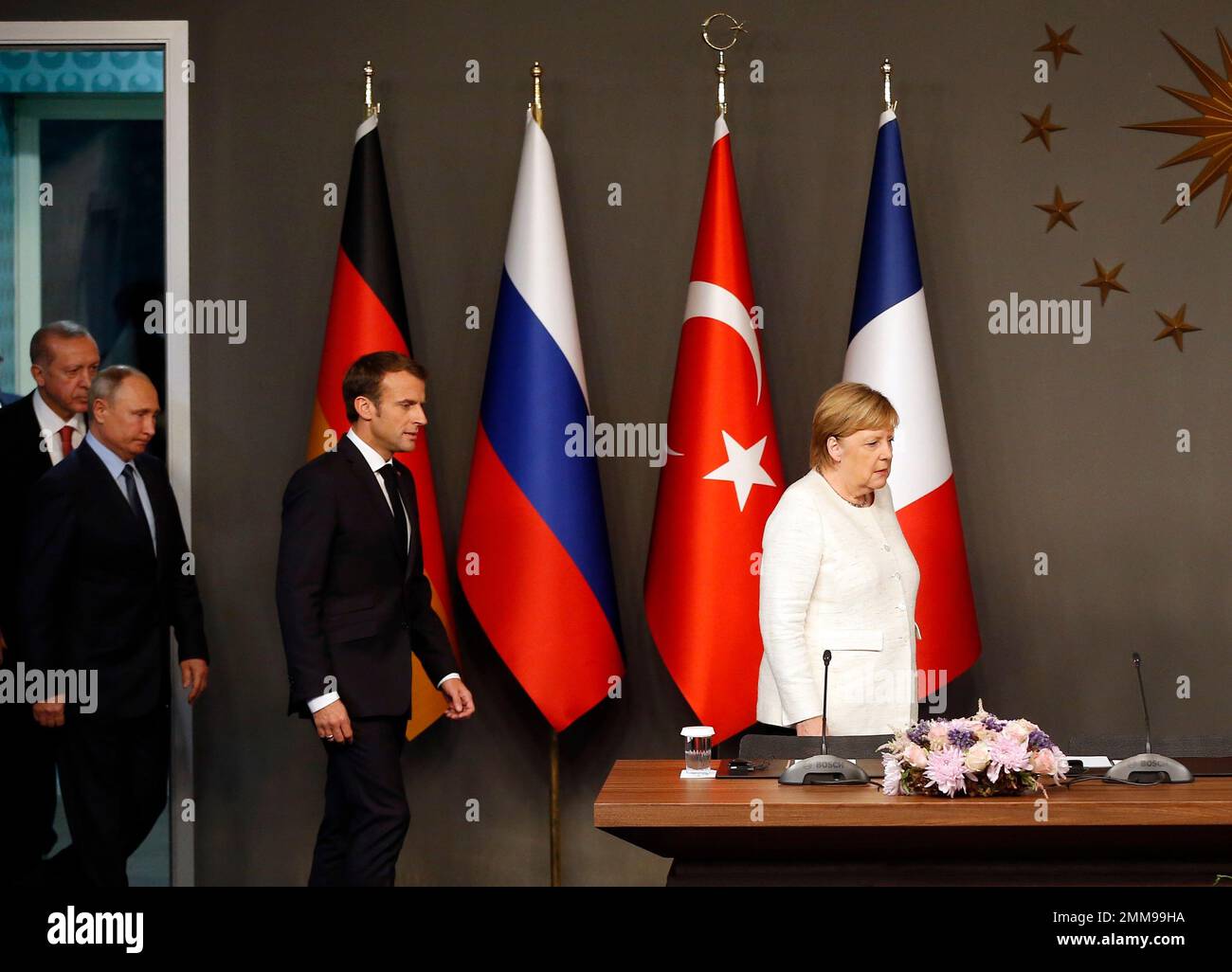 German Chancellor Angela Merkel, right, is followed by French President Emmanuel Macron, Russian President Vladimir Putin and Turkey's President Recep Tayyip Erdogan as they arrive for a news conference following their summit on Syria, in Istanbul, Saturday, Oct. 27, 2018. The leaders of Turkey, Russia, France and Germany were gathering for a summit Saturday in Istanbul about Syria, hoping to lay the groundwork for eventual peace in a country devastated by years of war. (AP Photo/Lefteris Pitarakis) Stock Photo