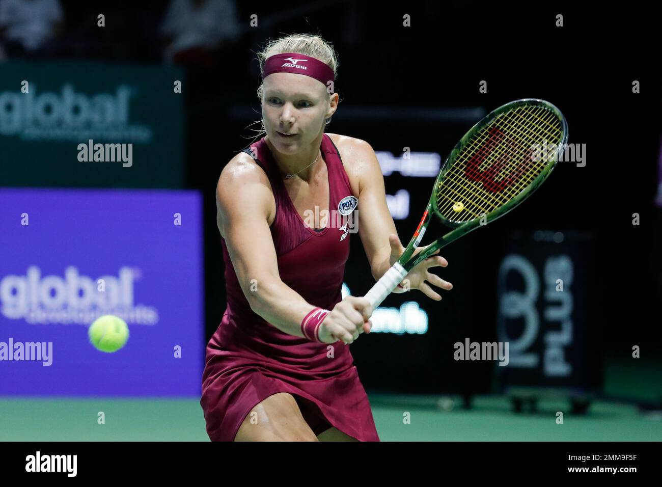 Kiki Bertens of the Netherlands plays a return shot while competing  againstNaomi Osaka of Japan during their women's singles match at the WTA  tennis finals in Singapore, Friday, Oct. 26, 2018. (AP