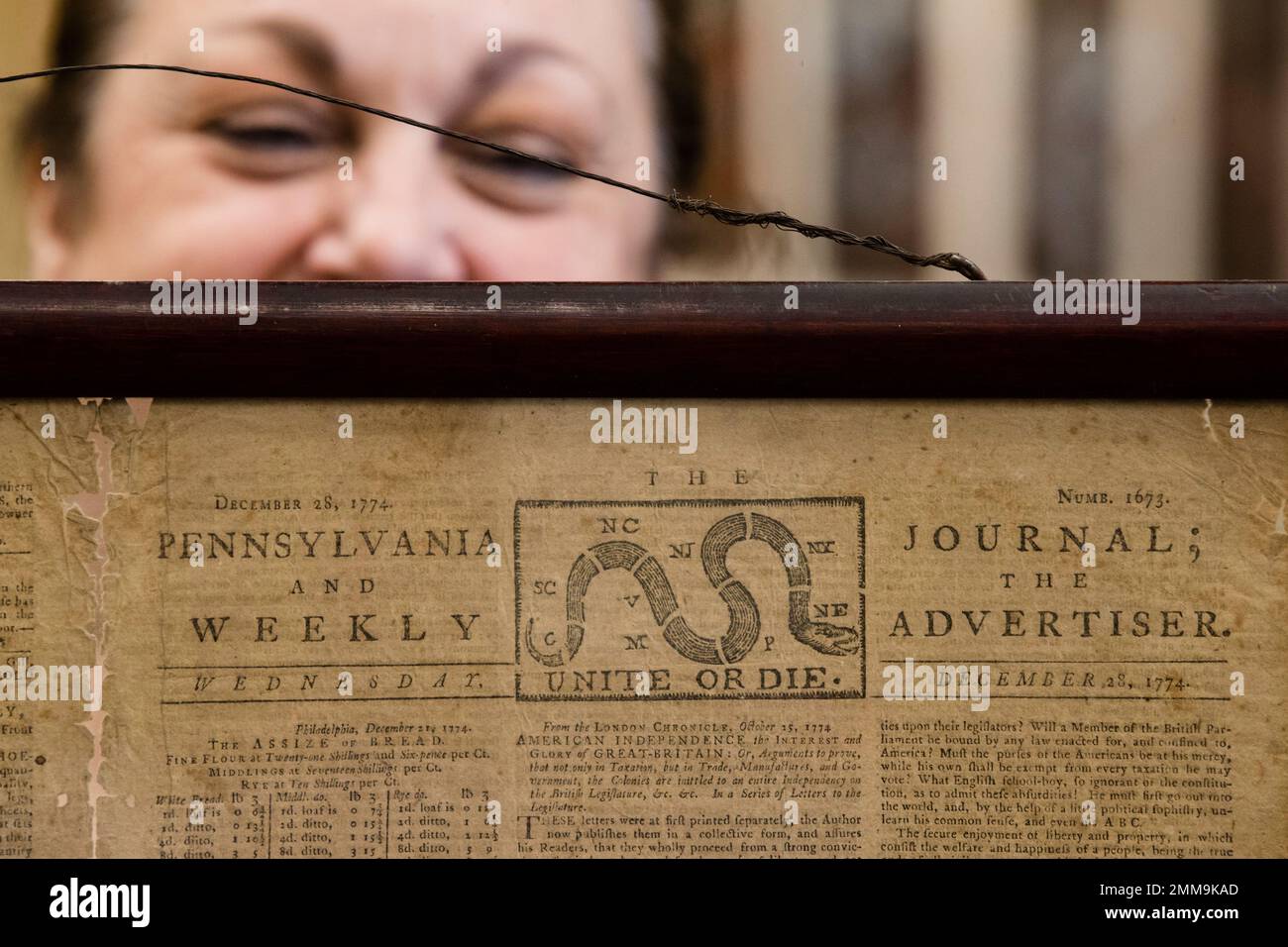 Heather Randall displays a Dec. 28, 1774 Pennsylvania Journal and the