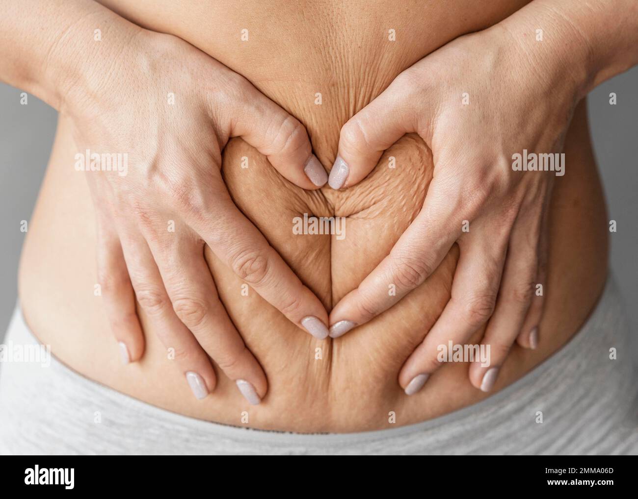 close up hands holding belly. Beautiful photo Stock Photo